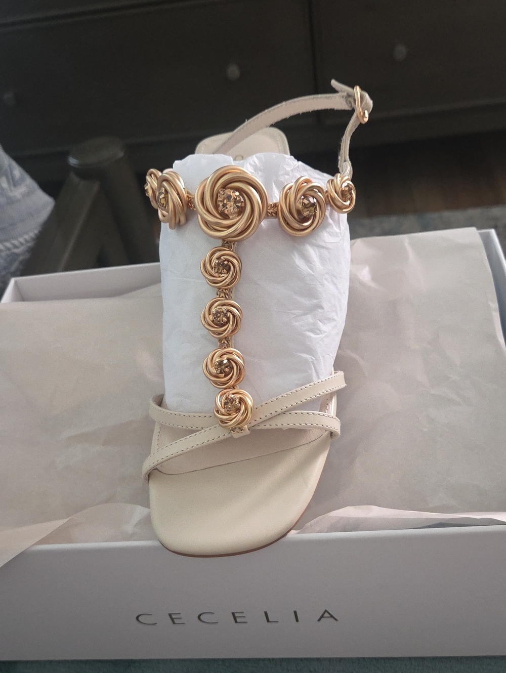 CECELIA NEW YORK Ivory Sandal with Gold Rosette T-Strap Detail